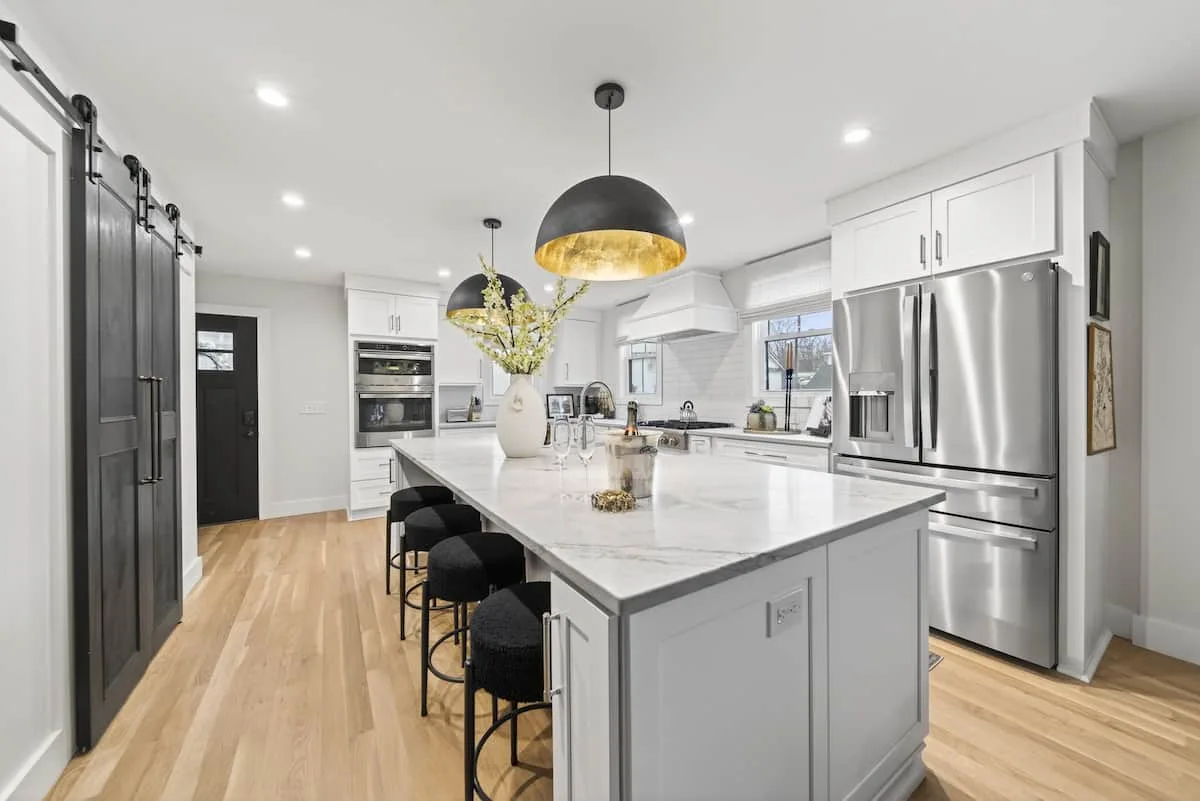 Modern kitchen with stainless steel appliances in White Porch Retreat